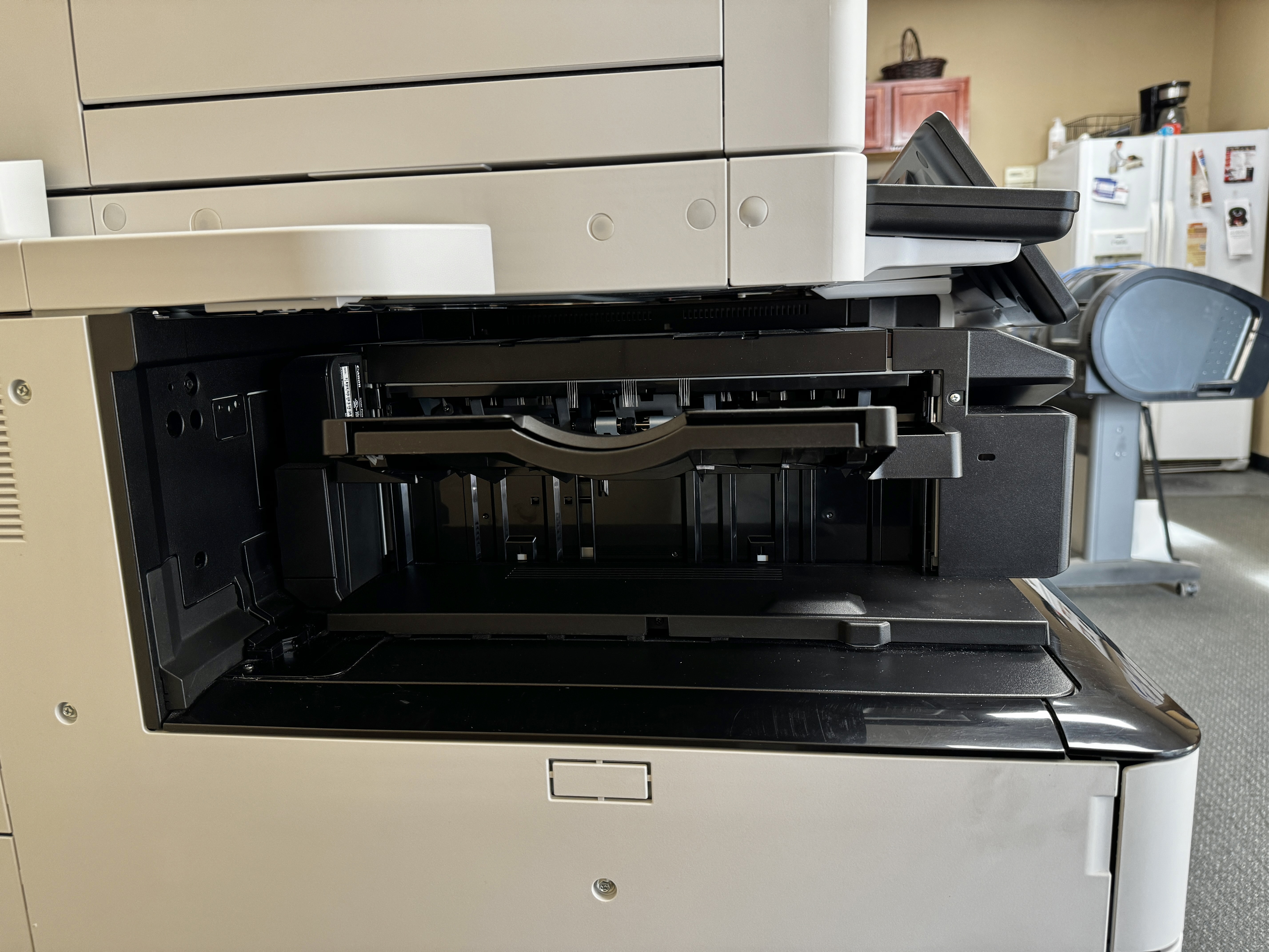 Internal finisher of a Canon c5540iii color copy machine with stapler.