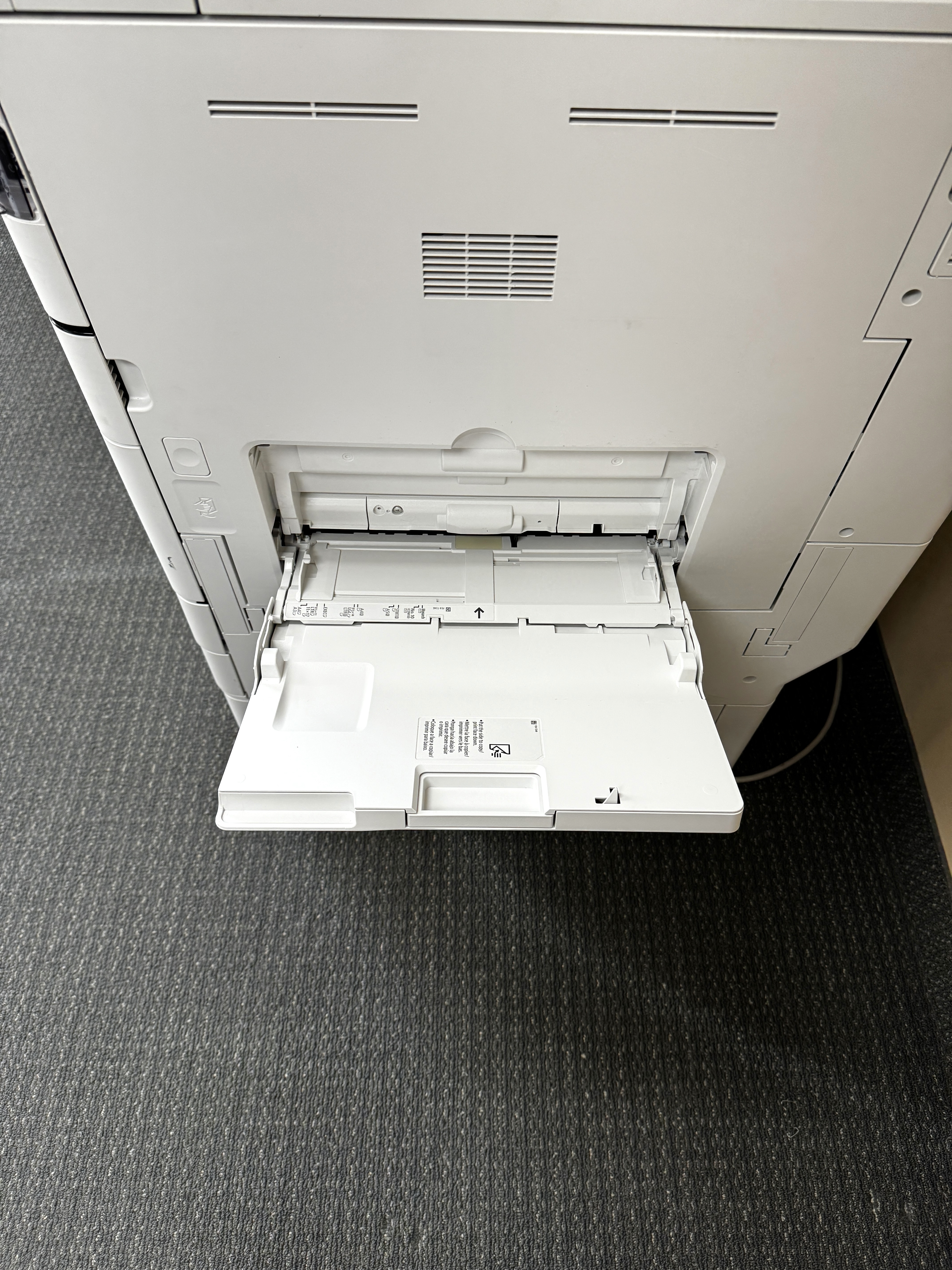 Manual tray for a Canon black and white copier.